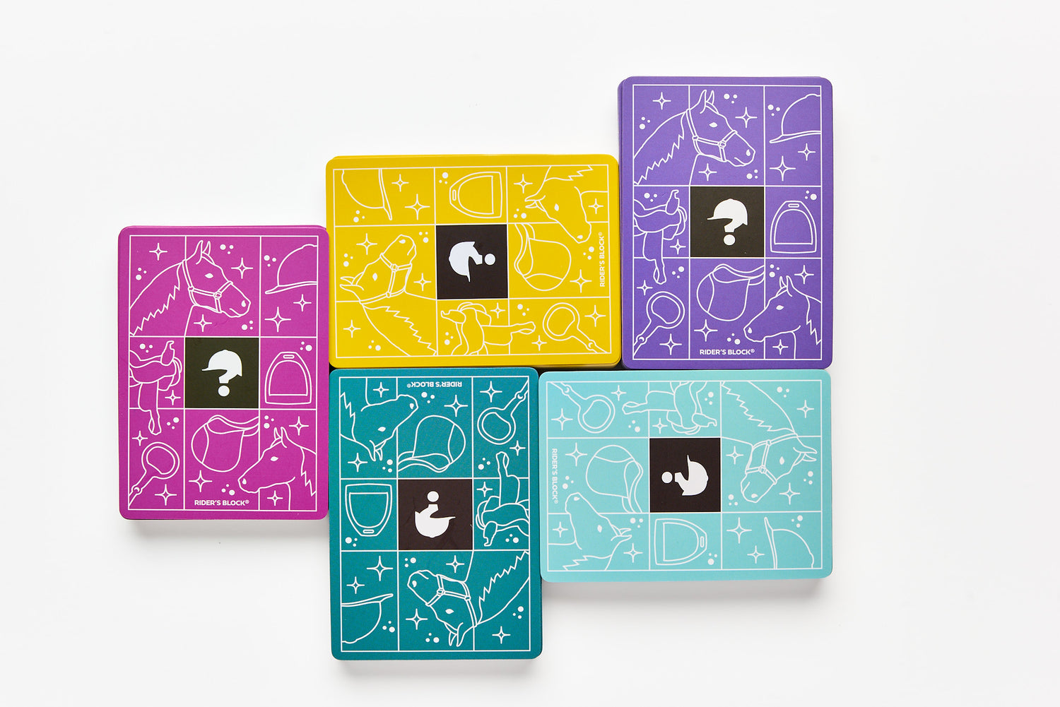 Set of colorful playing cards with geometric designs and question marks on a white background
