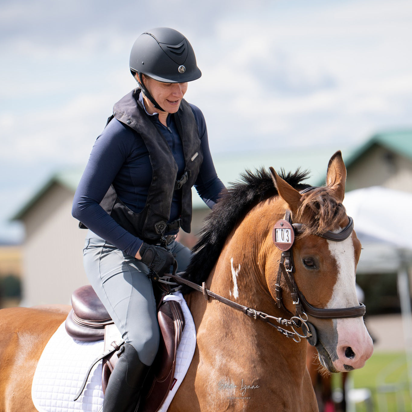 Person riding a brown horse in an outdoor setting