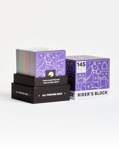 Two purple card decks with 'Rider's Block' branding on a white background