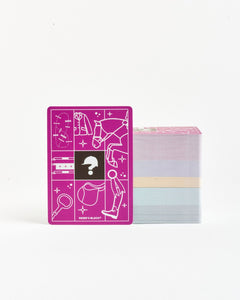 Pink card with white illustrations and a question mark symbol, next to a stack of colorful cards on a white background.